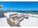 Rooftop terrace with seating and water views at 111 Golden Gate Pt # 401, Sarasota, FL 34236