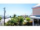 Ocean view from a balcony, showing beach, palm trees and buildings at 117 10Th N St # 122, Bradenton Beach, FL 34217