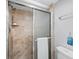 Walk-in shower with beige tile and glass enclosure at 117 10Th N St # 122, Bradenton Beach, FL 34217