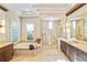 Spa-like bathroom with soaking tub, walk-in shower, and dual vanities at 11740 Rive Isle Run, Parrish, FL 34219