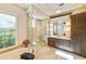 Elegant bathroom with soaking tub, glass shower, and dark wood cabinets at 11740 Rive Isle Run, Parrish, FL 34219