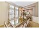 Bright dining room featuring a glass-top table and chandelier at 11740 Rive Isle Run, Parrish, FL 34219