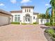 Elegant entryway with double doors and arched detail, beautiful landscaping at 11740 Rive Isle Run, Parrish, FL 34219