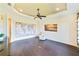 Gathering room with hardwood floors, a ceiling fan and coastal artwork at 11740 Rive Isle Run, Parrish, FL 34219