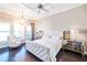 Luxurious main bedroom with a tufted headboard and dark hardwood floors at 11740 Rive Isle Run, Parrish, FL 34219