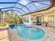 Relaxing pool and spa with covered patio and comfortable seating area at 11740 Rive Isle Run, Parrish, FL 34219