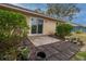 Private backyard patio with brick pavers, potted plants, and sliding glass door access at 1204 W 20Th Ave, Palmetto, FL 34221