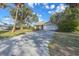 House exterior with a long driveway and palm trees at 1204 W 20Th Ave, Palmetto, FL 34221