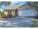 Tan house with white garage door and red front door at 1204 W 20Th Ave, Palmetto, FL 34221