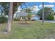 Landscaped front yard with mature trees and a spacious driveway at 1204 W 20Th Ave, Palmetto, FL 34221