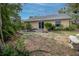 Back of house showing patio, landscaping, and a partially visible bench at 1204 W 20Th Ave, Palmetto, FL 34221