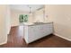 Kitchen with island, white cabinets, and wood-look flooring at 1204 W 20Th Ave, Palmetto, FL 34221