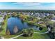 Stunning aerial view of a peaceful community with a central lake and lush greenery at 12941 Bliss Loop, Bradenton, FL 34211