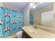 Bathroom with raccoon shower curtain, vanity, and single sink at 12941 Bliss Loop, Bradenton, FL 34211