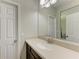 Simple bathroom with single sink and dark brown vanity at 12941 Bliss Loop, Bradenton, FL 34211