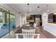 Bright dining area with dark wood table and chairs, near the kitchen at 12941 Bliss Loop, Bradenton, FL 34211