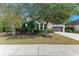 Two-story house with a tree in front and landscaping at 12941 Bliss Loop, Bradenton, FL 34211