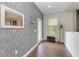 Bright foyer with wood floors and patterned wallpaper at 12941 Bliss Loop, Bradenton, FL 34211