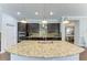 Island kitchen with granite countertops and stainless steel appliances at 12941 Bliss Loop, Bradenton, FL 34211