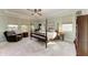 Main bedroom with a four-poster bed and ample natural light at 12941 Bliss Loop, Bradenton, FL 34211