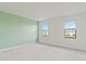 Spacious bedroom with light green accent wall and grey carpet at 15127 Lyla Ter, Bradenton, FL 34211