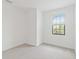 Bright bedroom with neutral walls and carpet, featuring a large window at 15127 Lyla Ter, Bradenton, FL 34211