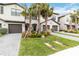 Two-story townhome with gray double garage doors and palm trees at 15127 Lyla Ter, Bradenton, FL 34211