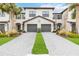 Two-story townhome with gray double garage doors and landscaped front yard at 15127 Lyla Ter, Bradenton, FL 34211