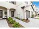 Townhome entry with walkway, landscaping, and gray garage door at 15127 Lyla Ter, Bradenton, FL 34211