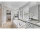 Luxurious bathroom featuring a large soaking tub and granite vanity at 16621 Berwick Ter, Lakewood Ranch, FL 34202