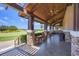 Covered patio area with tables and chairs, overlooking the golf course at 16621 Berwick Ter, Lakewood Ranch, FL 34202