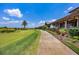 Landscaped walkway next to the golf course, leading to clubhouse at 16621 Berwick Ter, Lakewood Ranch, FL 34202