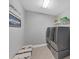 Bright laundry room with washer, dryer, and built-in storage at 16621 Berwick Ter, Lakewood Ranch, FL 34202