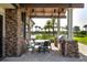 Outdoor kitchen and dining area with stone finishes at 16621 Berwick Ter, Lakewood Ranch, FL 34202