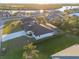 An aerial view of a waterfront property with a house and a private pool at 17250 Lake Worth Blvd, Port Charlotte, FL 33948