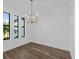 Dining room featuring hardwood floors and a stylish chandelier at 17250 Lake Worth Blvd, Port Charlotte, FL 33948