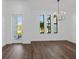 Bright dining room with hardwood floors and a modern chandelier at 17250 Lake Worth Blvd, Port Charlotte, FL 33948