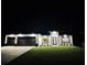 Modern house exterior at night, showcasing the architectural details and landscaping at 17250 Lake Worth Blvd, Port Charlotte, FL 33948