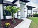 Modern house with a landscaped front yard, featuring palm trees and a walkway at 17250 Lake Worth Blvd, Port Charlotte, FL 33948