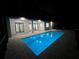 Inviting pool at night with surrounding patio at 17250 Lake Worth Blvd, Port Charlotte, FL 33948