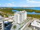 An aerial view of a coastal condo building with water and lush greenery views at 2050 Benjamin Franklin Dr # B304, Sarasota, FL 34236