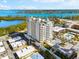 Aerial view of a condo building near the water with lush landscaping at 2050 Benjamin Franklin Dr # B304, Sarasota, FL 34236