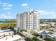 Aerial view of a white condo building with balconies overlooking the water at 2050 Benjamin Franklin Dr # B304, Sarasota, FL 34236