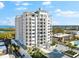 An aerial shot of a white condo building with a courtyard and water views at 2050 Benjamin Franklin Dr # B304, Sarasota, FL 34236