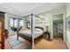 Spacious bedroom with a four-poster bed and private balcony access at 2050 Benjamin Franklin Dr # B304, Sarasota, FL 34236