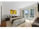 Serene bedroom with hardwood floors and access to a balcony at 2050 Benjamin Franklin Dr # B304, Sarasota, FL 34236