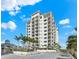 Luxury high rise building with paved courtyard and tropical landscaping at 2050 Benjamin Franklin Dr # B304, Sarasota, FL 34236