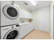 Laundry room with washer, dryer, cabinets and sink at 2050 Benjamin Franklin Dr # B304, Sarasota, FL 34236