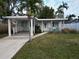 Ranch home with carport and small front yard at 210 Briggs Ct, Sarasota, FL 34237