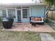 Relaxing patio with a wicker couch, terracotta tiles, and a built-in grill at 210 Briggs Ct, Sarasota, FL 34237